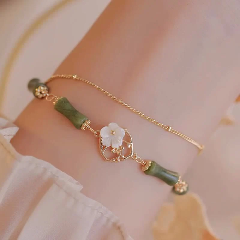 Bracciale Buddha Stones in rame placcato oro 14k con fiore di bambù, peridoto e doppio strato di ricchezza