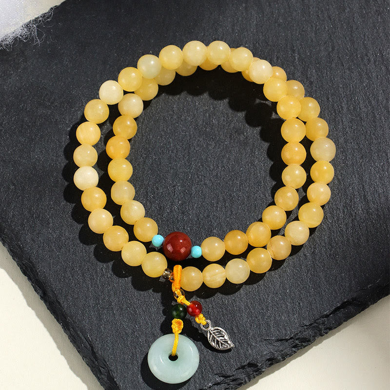 Bracciale della ricchezza con fibbia della pace a doppio giro in Buddha Stones e topazio