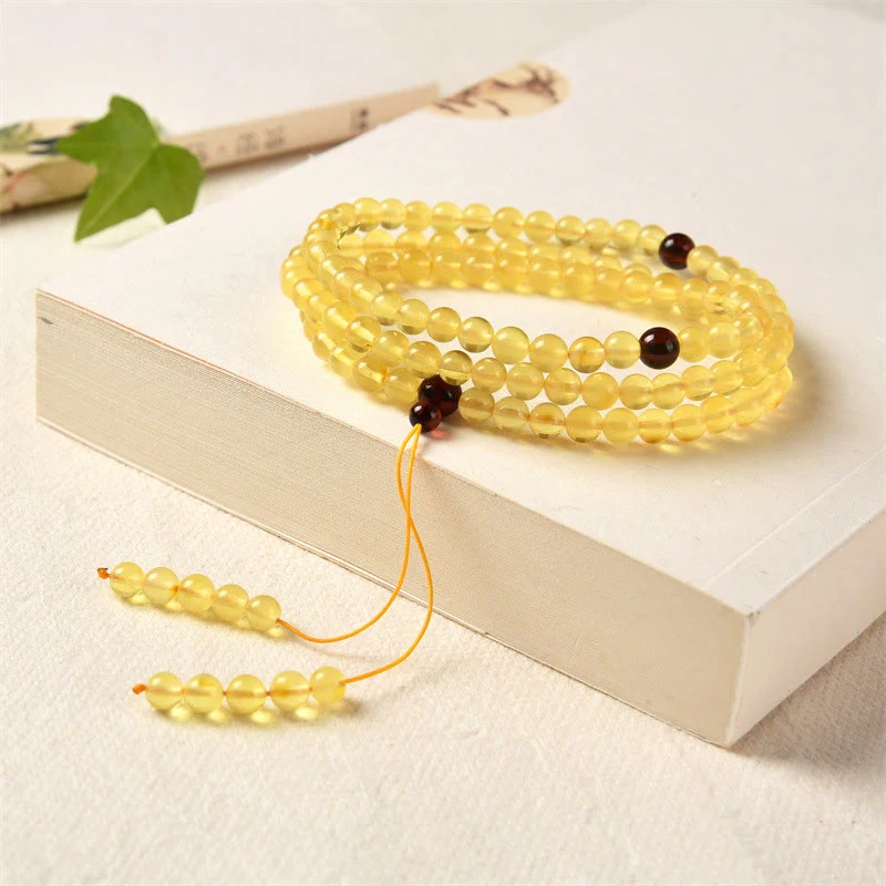 Braccialetto anti-ansia con 108 perline di mala in ambra naturale e trasparente Buddha Stones - Image 2