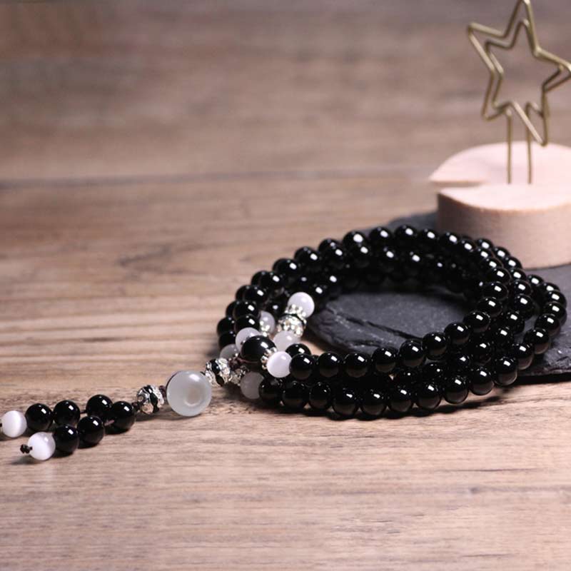 Braccialetto di meditazione con perline di cristallo bianco e onice nero Buddha Stones - Image 4