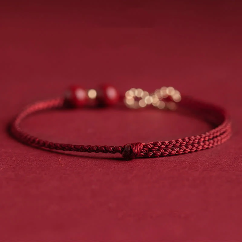 Braccialetto alla cavigliera con simbolo dell'infinito dorato e cordino rosso con Buddha Stones e cinabro. - Image 8