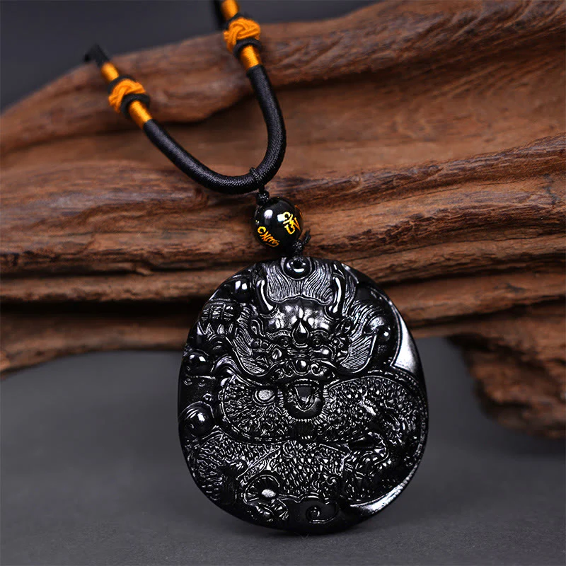 Collana con ciondolo di protezione in ossidiana nera naturale con drago intagliato rotondo in Buddha Stones