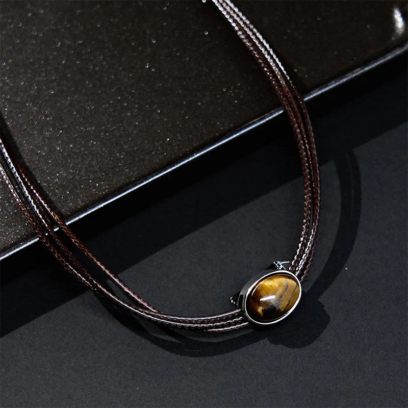 Collana con ciondolo in corda di cera con protezione ellittica in occhio di tigre naturale Buddha Stones